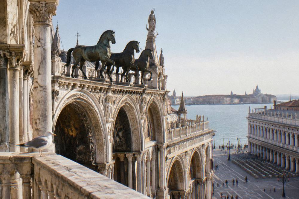 The bronze horses and arched loggia above the basilica's facade seen from the square