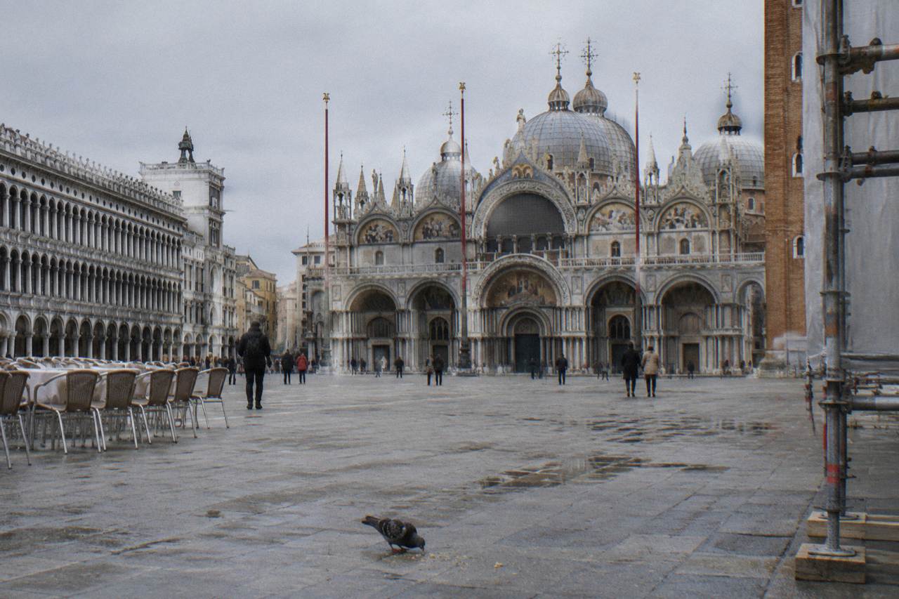 The domes and brickwork of St Mark's Basilica seen from a quiet corner of the square