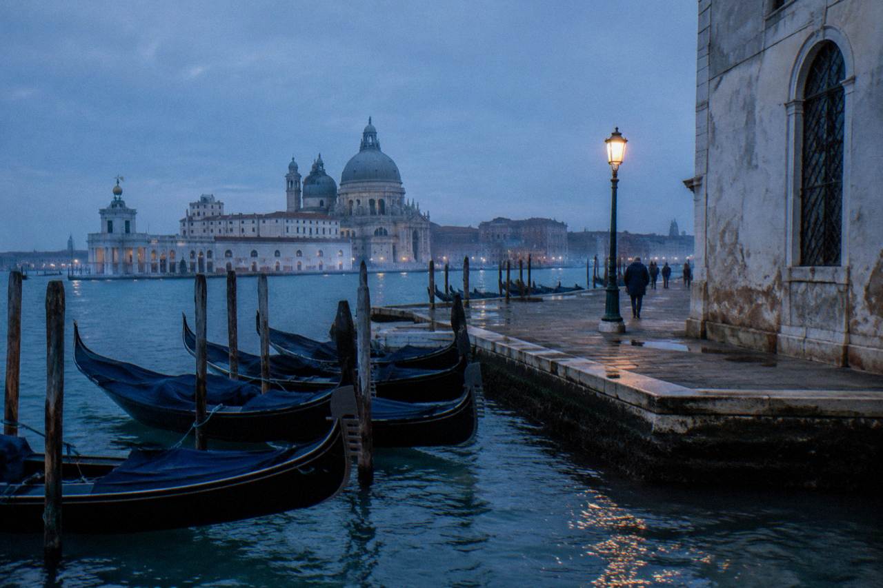 Quiet Venice canal with moored gondolas and old brick facades in morning light