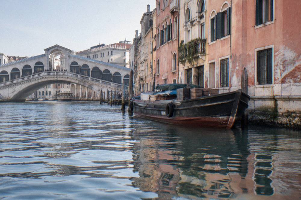 The Rialto area with canal water reflecting old palace facades