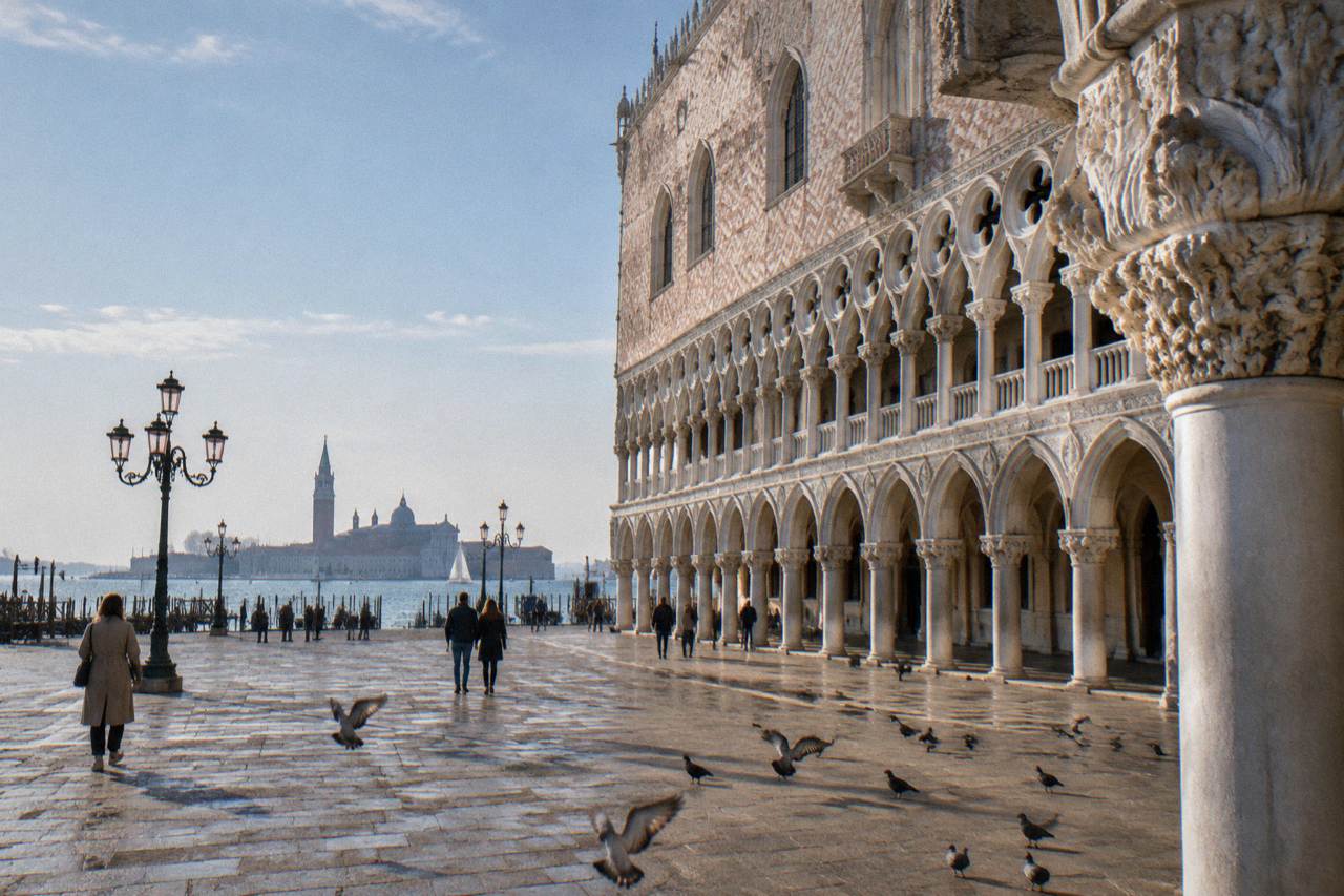 Gothic facade and arcaded waterfront of the Doge's Palace beside the lagoon in Venice
