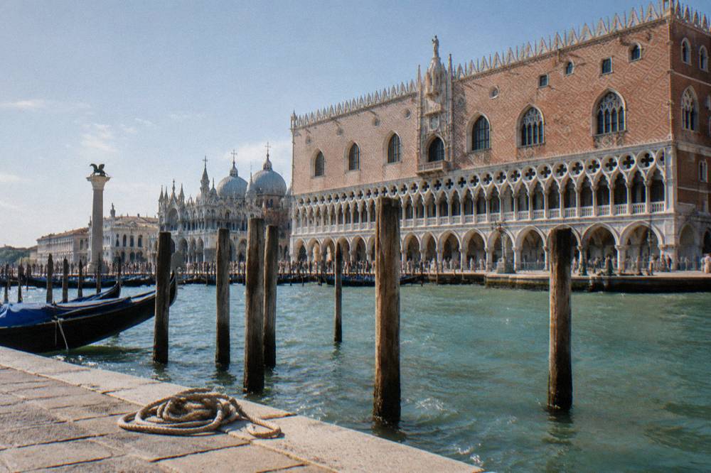 Gothic palace facade of the Doge's Palace beside a canal in Venice