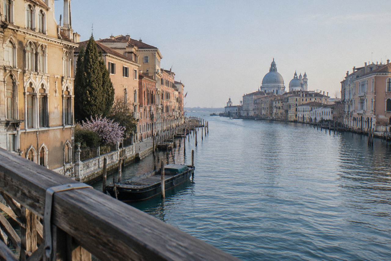 Grand Canal waterfront palazzi in Venice seen from a stone quay at morning