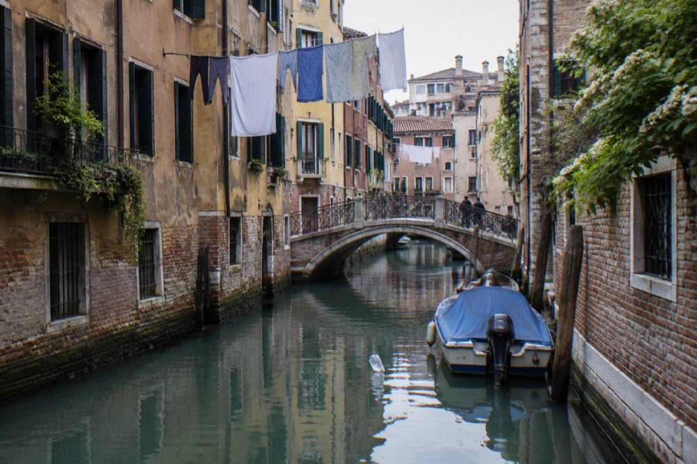 Cannaregio canal in Venice with small bridges and laundry hanging above the water