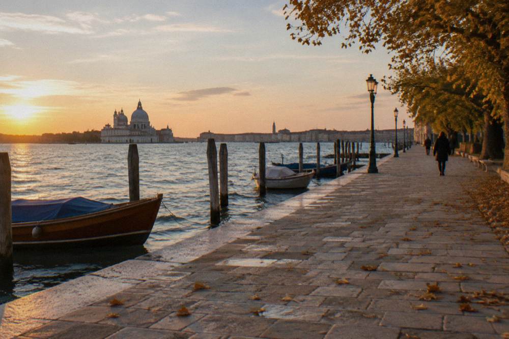 Wide stone quay in Dorsoduro facing open lagoon water with moored boats