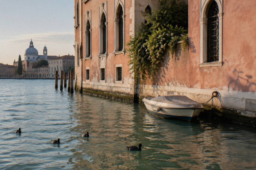 Canal side building with arched windows along a quiet Venetian street
