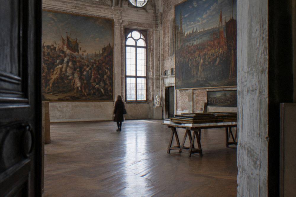 Museum gallery hall with paintings hung on interior walls