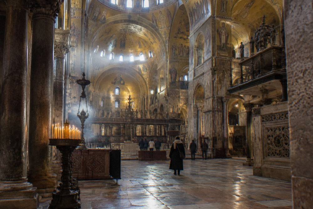 The golden mosaic interior and arched ceilings inside St Mark's Basilica