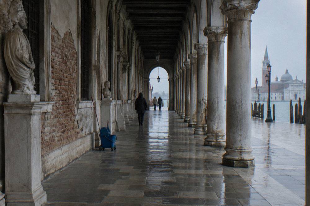The arcaded Procuratie facades along St Mark's Square in early morning light