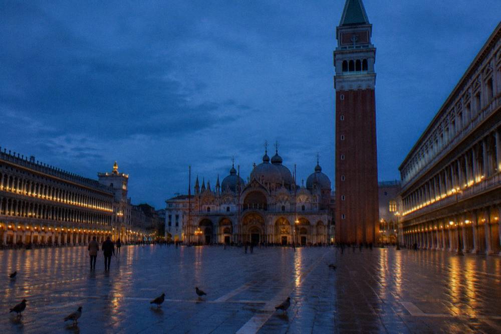 The open expanse of Piazza San Marco with the Basilica facade and campanile under a wide sky